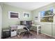 Bright bedroom featuring a white desk, chair, and large window, perfect for a home office setup at 7862 W Euclid Pl, Littleton, CO 80123