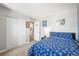 Comfortable bedroom with blue comforter, closet, and neutral walls, creating a cozy and inviting atmosphere at 7862 W Euclid Pl, Littleton, CO 80123