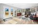 Bright living room with fireplace, built-in shelving, and large glass doors leading to the backyard at 7862 W Euclid Pl, Littleton, CO 80123