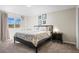 Cozy bedroom with neutral decor, comfortable bed, and natural light from the window at 7862 W Euclid Pl, Littleton, CO 80123