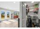 Mud room with utility sink, storage shelves, and direct access to the backyard at 7862 W Euclid Pl, Littleton, CO 80123