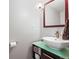 Stylish powder room features a modern vanity, vessel sink, and decorative mirror at 7862 W Euclid Pl, Littleton, CO 80123