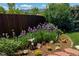 Landscaped backyard with irises, rocks, and wooden fence at 7913 Grasmere Dr, Boulder, CO 80301