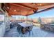 Covered patio features a dining table, bar seating and mountain views at 7913 Grasmere Dr, Boulder, CO 80301