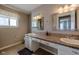 Bathroom with double sinks, large mirror, and tile flooring at 7913 Grasmere Dr, Boulder, CO 80301