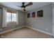 Bright bedroom with window, ceiling fan, and neutral wall colors at 7913 Grasmere Dr, Boulder, CO 80301