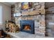 Inviting stone fireplace with a rustic wooden mantel at 7913 Grasmere Dr, Boulder, CO 80301