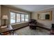 Sitting area with leather chair and bay window overlooking snowy scene at 7913 Grasmere Dr, Boulder, CO 80301