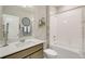 Bright bathroom featuring a combination shower and tub, a sleek vanity, and neutral decor at 4621 Cattle Cross Trl, Castle Rock, CO 80104