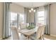 Inviting dining room with a rustic table, upholstered chairs, and lots of natural light at 4621 Cattle Cross Trl, Castle Rock, CO 80104