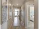 Inviting hallway features wood-like floors, neutral paint, and eye-catching art leading to an airy living space at 4621 Cattle Cross Trl, Castle Rock, CO 80104