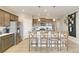 Charming kitchen boasts a central island with barstools, stainless steel appliances, and wood-look floors at 4621 Cattle Cross Trl, Castle Rock, CO 80104