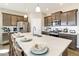 Kitchen with an oversized island, stainless appliances, and pendant lighting offering the perfect cooking space at 4621 Cattle Cross Trl, Castle Rock, CO 80104
