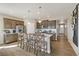 Modern kitchen features stainless steel appliances, a large center island with barstool seating at 4621 Cattle Cross Trl, Castle Rock, CO 80104