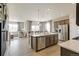 Spacious open-concept kitchen with stainless appliances and large island, flowing into the living area at 4621 Cattle Cross Trl, Castle Rock, CO 80104
