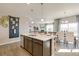 Open concept kitchen with a large center island, pendant lighting, and dining area at 4621 Cattle Cross Trl, Castle Rock, CO 80104
