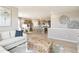 Open-concept living room and kitchen featuring modern decor, stainless steel appliances, and hardwood floors at 4621 Cattle Cross Trl, Castle Rock, CO 80104
