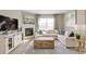 Spacious living area with a fireplace, modern furnishings, and large window providing ample natural light at 4621 Cattle Cross Trl, Castle Rock, CO 80104