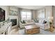 Comfortable living space with modern decor, a fireplace, and a large window for natural light at 4621 Cattle Cross Trl, Castle Rock, CO 80104