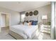Serene main bedroom with a tufted headboard, side tables, and decorative wall art at 4621 Cattle Cross Trl, Castle Rock, CO 80104