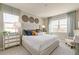 Cozy main bedroom features a tufted headboard, decorative wall art, and ample natural light at 4621 Cattle Cross Trl, Castle Rock, CO 80104