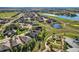 Stunning aerial view of community with a pond, golf course, lush greenery, and well-maintained landscaping at 15333 Heritage Cir, Thornton, CO 80602