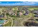 Wide aerial perspective capturing the community, golf course, ponds, and landscaped walking trails at 15333 Heritage Cir, Thornton, CO 80602