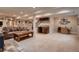 Spacious basement living area with wet bar, carpeted floors and a fireplace at 15333 Heritage Cir, Thornton, CO 80602