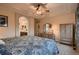 Bedroom showing tray ceiling, ceiling fan, full-size bed and adjoining bathroom at 15333 Heritage Cir, Thornton, CO 80602