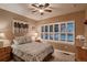 Inviting bedroom with shuttered windows providing natural light, ceiling fan and closet at 15333 Heritage Cir, Thornton, CO 80602