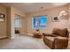 Bedroom featuring a mirrored closet and a comfortable chair near a large window at 15333 Heritage Cir, Thornton, CO 80602