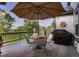 Relaxing deck with a dining area and a grill perfect for outdoor entertaining at 15333 Heritage Cir, Thornton, CO 80602
