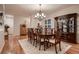 Formal dining room with hardwood floors, chandelier, and classic wood furniture at 15333 Heritage Cir, Thornton, CO 80602