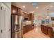 Modern kitchen with stainless steel refrigerator, granite countertops, and hardwood floors at 15333 Heritage Cir, Thornton, CO 80602