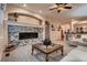 Cozy living room features a modern fireplace with stone surround, and plush carpeting at 15333 Heritage Cir, Thornton, CO 80602
