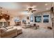 Open-concept living and dining area with fireplace and large windows for natural light at 15333 Heritage Cir, Thornton, CO 80602