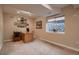 Comfortable carpeted office with a window, desk, and art at 15333 Heritage Cir, Thornton, CO 80602
