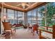 Relaxing sun room with ample windows offering panoramic views and comfortable seating at 15333 Heritage Cir, Thornton, CO 80602