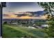 Scenic view of the community with a pond and vibrant sunset, creating a serene atmosphere at 15333 Heritage Cir, Thornton, CO 80602
