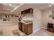 Basement wet bar features cabinetry, a sink, and a mini-refrigerator for entertaining at 15333 Heritage Cir, Thornton, CO 80602