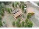 Beautiful aerial view of the home's setting amidst lush greenery and a serene environment at 11398 Ranch Elsie Rd, Golden, CO 80403