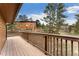 Large back deck offering stunning views of mature trees and a separate building, creating a private retreat at 11398 Ranch Elsie Rd, Golden, CO 80403