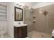 Bathroom with walk-in shower, neutral tile, and ample storage at 11398 Ranch Elsie Rd, Golden, CO 80403