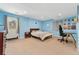 Spacious bedroom with blue walls, neutral carpet, and access to the outside through a door at 11398 Ranch Elsie Rd, Golden, CO 80403