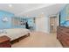 Bright bedroom featuring blue walls, neutral carpet, a double closet, and natural lighting at 11398 Ranch Elsie Rd, Golden, CO 80403