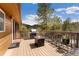 Inviting outdoor deck featuring a grill, firepit, seating, and views of the forest at 11398 Ranch Elsie Rd, Golden, CO 80403