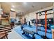 Spacious home gym featuring a variety of workout equipment, blue mat flooring and natural light at 11398 Ranch Elsie Rd, Golden, CO 80403