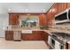Modern kitchen featuring granite countertops, stainless steel appliances, and ample cabinet space with a mountain view at 11398 Ranch Elsie Rd, Golden, CO 80403