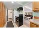 Functional kitchenette featuring a compact oven, fridge, and storage, ideally situated near an entertainment area at 11398 Ranch Elsie Rd, Golden, CO 80403