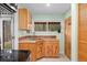 Efficient kitchenette with classic wooden cabinets, a sink with a window view, and ample natural light at 11398 Ranch Elsie Rd, Golden, CO 80403